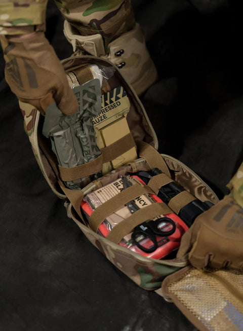 Open IFAK Trauma Kit with CAT Tourniquet and Israeli Bandage in MOLLE pouch for military combat, car camping, hiking.