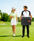 Man holding 2 Layer Golf Trunk Organizer With 2 Shoe Compartments on golf course, green background, casually dressed golfers