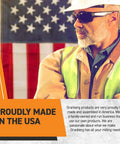 Worker in safety gear stands in front of American flag, text reads 'Proudly Made in the USA', emphasizing craftsmanship.