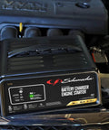 Beast 4 In 1 Car Battery Charger And 50 Amp Engine Starter with 10 Amp Boost placed on a car engine