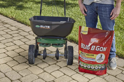 Bag of All In One Lawn Insect Killer next to lawn spreader on pavement, designed to kill ants, fleas, ticks, and more for 3 months