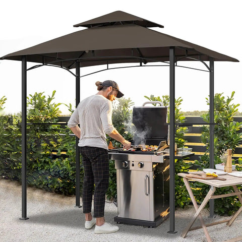 Man grilling under Patio Grill Gazebo Canopy With Double Tier Roof For Outdoor BBQ And Backyard Use Sturdy Powder Coated Steel Frame