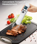 2-In-1 Infrared Thermometer Gun With Meat Probe measuring steak temperature on cutting board with vegetables