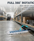 42 Inch Commercial Dust Mop With Extra Wide Flat Head Heavy Duty Swivel Design And Quick Release Handle That Picks Up Dust Without A Sweat For Warehouses And Commercial Spaces in a warehouse, showing swivel action.