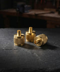 Professional Grade Beefy Brass Refrigeration Valve Caps With Slick Knurled Nozzles For Ac Systems And Coolant Lines Leak Proof Field Service Covers No Sweat Maintenance 30 Pack, three brass caps on slate surface.