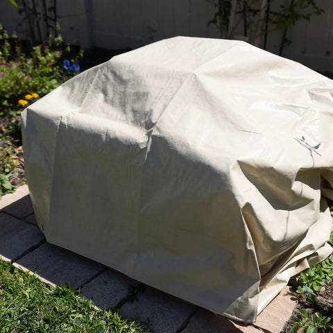 Heavy Duty Waterproof Tarp 20 Ft By 30 Ft 12 Mil Thick Tan Tarp With Reinforced Corners covering outdoor furniture