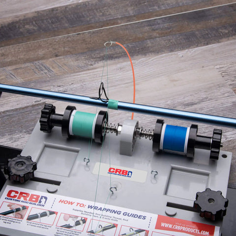 Close-up of Compact Hand Wrapper System With Two Spool Thread Tensioner, featuring threaded rod and spring-loaded knobs.