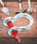 One Half Inch Galvanized Screw Pin Anchor Shackle Two Ton Kickass Lifting Rig For Trucks Built Strong With Zero Drama Off Road Tow Hook Mount Industrial Hardware Kit on wooden table with tools.