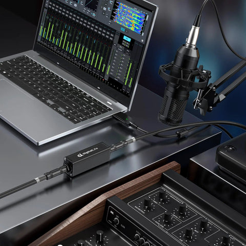 Studio setup with 6.35mm Ground Loop Noise Isolator for guitar amp and mixer, reducing hum on laptop and mic interface.