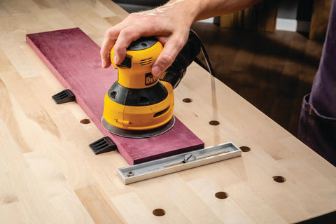 Using low profile adjustable go to workbench stop for wooden peg holes three quarters inch with aluminum body and sander