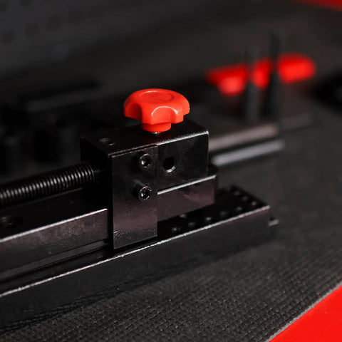 Close-up of Mini Rod Bender Tool For Metalwork Universal Bending Machine For Wire Tubing with red grip handle on black base.