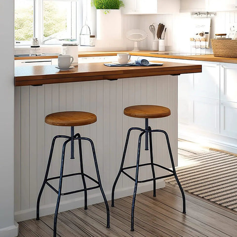 Two wooden seat barstools with black steel legs at a modern kitchen countertop, featuring Rock Solid 10 Inch Countertop Support Brackets 3 Pack.