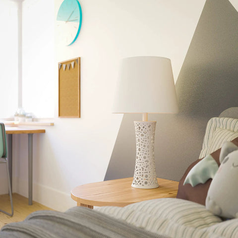 Bright White Ceramic Table Lamp With Bubble Pattern on end table in living room, soft glow, modern decor style