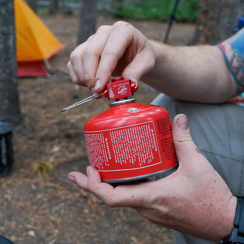 Fuel Transfer Kit For Backpacking And Camping With Flow Control Valve And Integrated Pressure Vent in hand outdoors