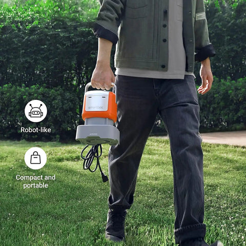 Person carrying the Powerful Submersible Water Pump Kit In Orange With 2800 GPH Flow, 25 Ft Lift, 1/2 HP Motor, 6 Hose Kit