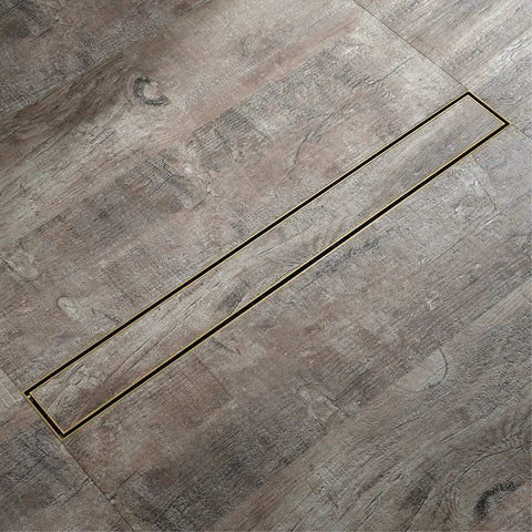 Heavy Duty Linear Shower Drain 23.6 Inch Invisible Floor Trench With Snap Off Hair Catcher Screen 304 Stainless Steel shown in brushed gold on tiled floor.