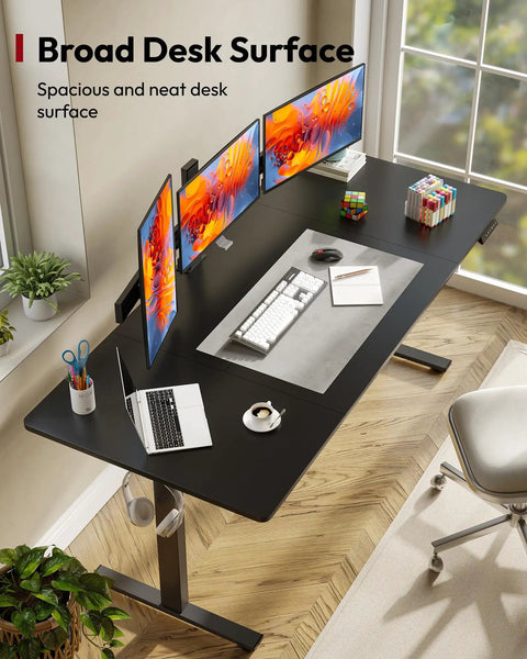 Overhead view of Electric Standing Desk With 71-Inch By 32-Inch Splice Board Desktop, black frame, three monitors, chair.