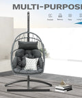 Egg Chair With Stand For Indoor And Outdoor Use, gray hanging rattan wicker swing chair with cushion, shown on patio.