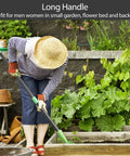 Person using Beastly Heavy Duty Thatch Rake For Lawns With 54 Inch Handle in garden with raised bed and plants.