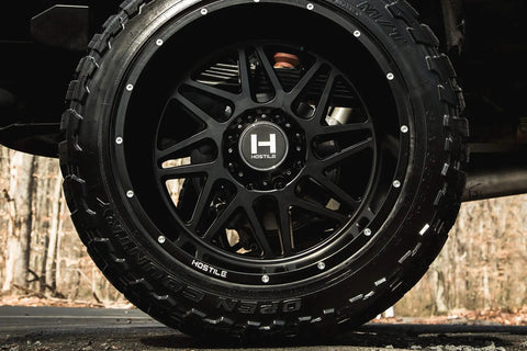 22X12 Satin Black Truck Wheels With 6X135 Bolt Pattern And Minus Forty Four Offset Aggressive Off Road Rims close-up view.