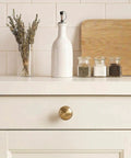Champagne Bronze Cabinet Knobs Set Of 10 For Kitchen Cupboards And Dressers, Zinc Alloy Pulls, shown on white kitchen drawer