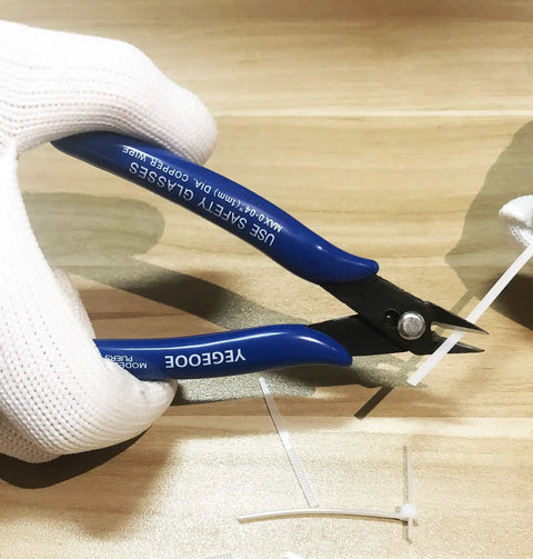 10 Pack Flush Wire Cutters Pliers Set With Diagonal Side Cutting Jaws For Jewelry Making And Crafts Ultra Sharp High Carbon Steel Blades Five Inch Palm Size For Clean Precise Cuts in use cutting white wire on wooden surface