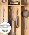 Ten Pack Tough As Nails 304 Stainless Steel Screw Eye Hooks Two Point Five Inch displayed with kitchen tools in a wooden organizer.