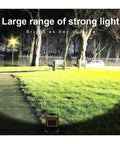 JUDYSSY 1000W Solar Flood Light Portable Led Reflector Spotlight illuminating a garden, showcasing strong light range at night.