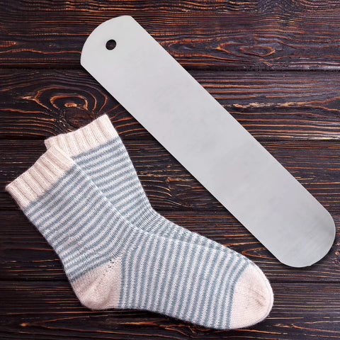 Aluminum Straight Sock Jigs For Sublimation Projects Flat Sock Press Inserts With Hanging Hole, next to socks on table.