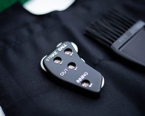 Umpire Gear Kit With 4-Dial Indicator, Plate Brush, And Pro-Style Cloth Bag For Baseball Games on black cloth surface