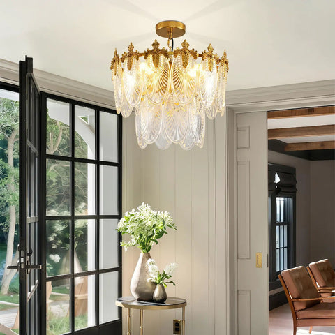 Next Level Two Layer Gold Crystal Glass Chandelier And Four Light Round Pendant Fixtures With Brushed Brass Finish in modern room.