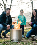 Family roasting marshmallows over Ranger Portable Outdoor Fire Pit With Stand Stainless Steel Firepot For Wood Burning And Low Smoke