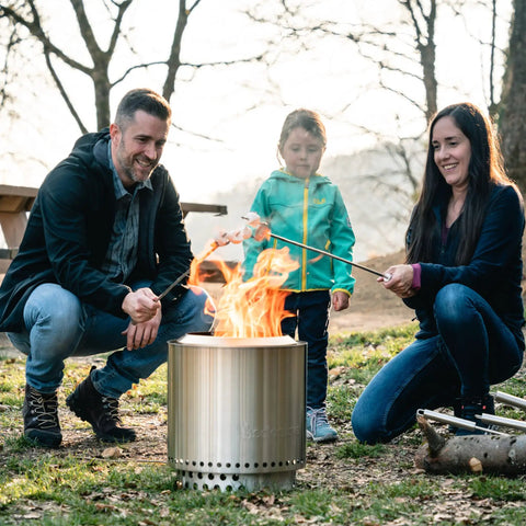 Family roasting marshmallows over Ranger Portable Outdoor Fire Pit With Stand Stainless Steel Firepot For Wood Burning And Low Smoke