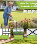 Woman watering plants beside Tall 31.5 Inch Decorative Garden Fence Panels 14 Pack No Dig Metal Wire Border for Dogs and Pets