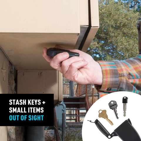 Person using waterproof magnetic key box for spare keys with secure magnetic key holder under an outdoor metal structure.