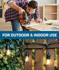 Man using a saw indoors, outdoor string lights hanging on a fence covered with leaves, highlighting versatility for use.