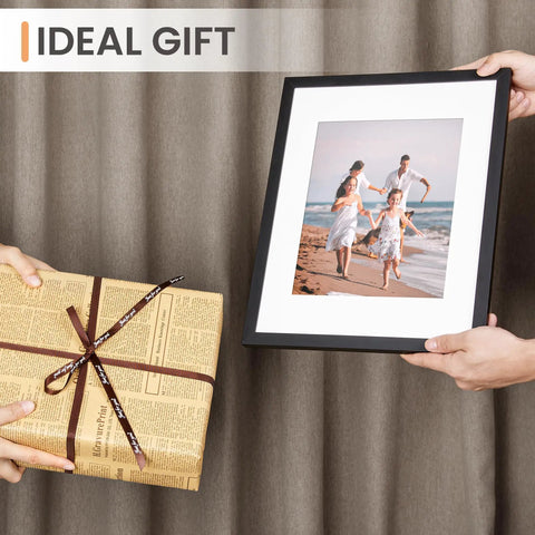 Two hands holding Classic Black 11x14 Picture Frame With Mat For 8x10 Photos Or 11x14 Without Mat, ideal gift suggestion.