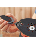 A hand holding a triangular sanding head attachment for Pick Up This Bad Boy Heavy Duty Multi Sander With 200 Watt Motor, 4 In 1.