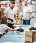 Workers wearing Lightweight Seamless Knit PU Coated Work Gloves for Men and Women with Smooth Palm Grip handling boxes.
