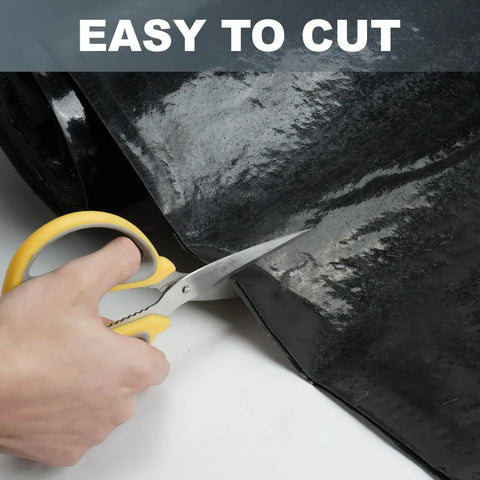 A hand holding scissors cutting the Rock Solid Self Adhesive Rubber Roofing Membrane Roll 39 By 164 Feet Waterproof Leak Tape in black.