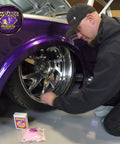 Wizards Metal Polish 3oz for silver, brass, stainless & aluminum; applied to chrome wheel of purple car (front view)