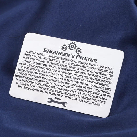 Stainless steel Engineer's Prayer wallet card on blue fabric, part of Techie Engineer Gift For Men Engineers Prayer Wallet Card Featuring Electrical And Mechanical Engineering Themed Jewelry For Engineers A Solid Fathers Day Retirement Gift For Dad Or Grandfather.