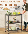 Man using Three Tier Rolling Utility Kitchen Cart With Heavy Duty Metal Construction And Wire Shelves On Wheels in kitchen