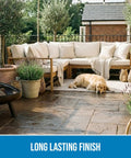 Patio with couch, plants, and a dog on wet-look stone sealed with SP-1104 Gloss Sealer 5 Gallon Ready To Use Wet Look Water Repellent.