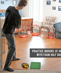 Person practicing indoors with Chipster Range Golf Chipping Practice Net Target System With Carrying Case Red Fast Popup Setup