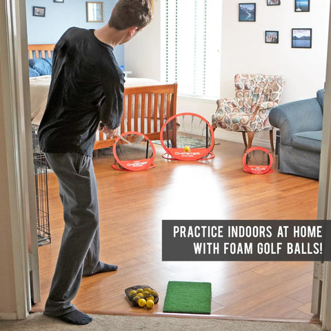 Person practicing indoors with Chipster Range Golf Chipping Practice Net Target System With Carrying Case Red Fast Popup Setup
