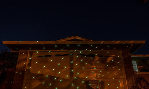Motion Snow Fall Light Show With White Laser And 7 Color Star Effects Christmas Lights on house facade, night view
