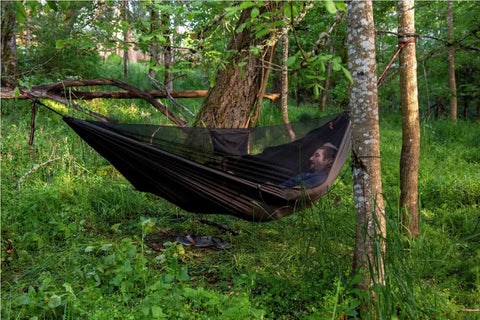 Person relaxing in Kompound Camping Hammock With Net And Warm Internal Cover Ultralight Portable Hammock With Tree Friendly Straps