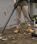 Person using Pro Grade 6 Gallon Wet Dry Vacuum With 4 Peak HP Motor And Stainless Steel Tank In Silver And Yellow for cleanup