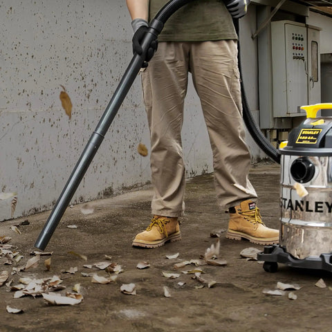Person using Pro Grade 6 Gallon Wet Dry Vacuum With 4 Peak HP Motor And Stainless Steel Tank In Silver And Yellow for cleanup